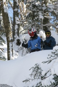 An image of Ty peering over a cliff in the Wood's Hole Glades area at Bolton Valley Ski Resort in Vermont as he prepares to jump off