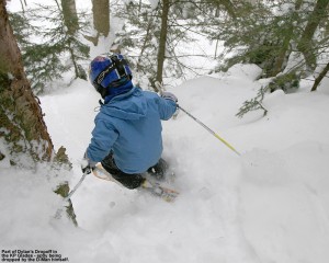 Image of Dylan dropping a cliff into the powder