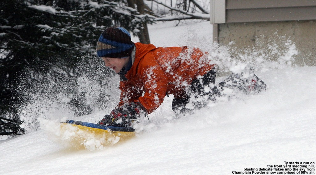 An image of Ty sledding in extremely dry, 2% water content powder at our house in Waterbury, Vermont