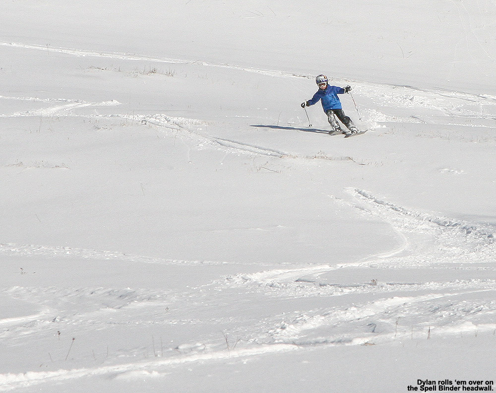 An image of Dylan carving a huge arc down the headwall of the Spell Binder trail at Bolton Valley Ski Resort in Vermont