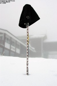 An image showing a ski measurement pole indicating 22" of snow at the Cliff House at Stowe Mountain Resort in Vermont on Memorial Day Weekend