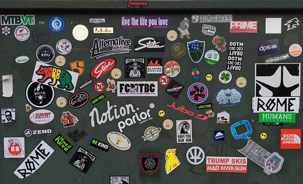 An image of various stickers outside the Piecasso restaurant in Stowe Vermont