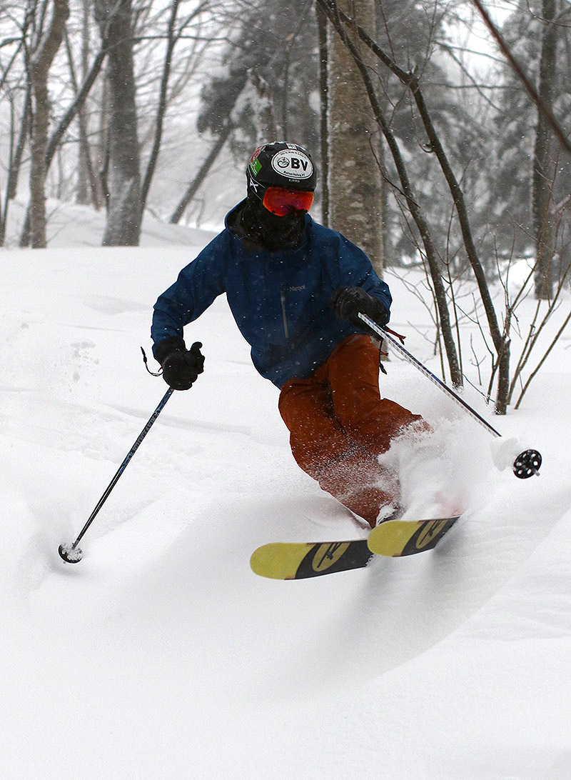 An image of Ty skiing powder in the trees at Bolton Valley Ski Resort in Vermont