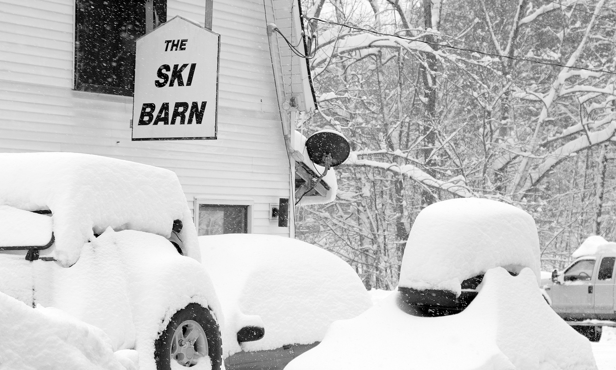 An image of heavy snow accumulations from Winter Storm Skylar at the Ski Barn area along the Bolton Valley Access Road near Bolton Valley Ski Resort in Vermont
