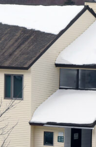 An image of snow on the roof of one of the condominium complexes in the village at Bolton Valley Ski Resort in Vermont