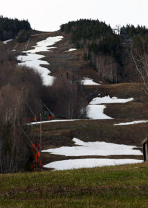 An image showing some of the remaining snow on May on the Spruce Peak trails at Stowe Mountain Resort in Vermont