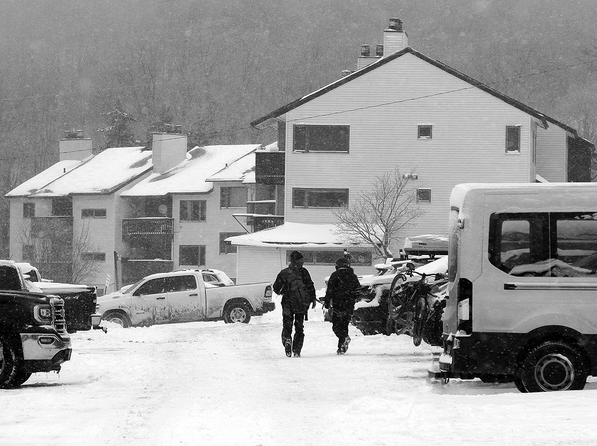 An image of skiers heading to the lifts in the Bolton Valley Village during Winter Storm Carrie