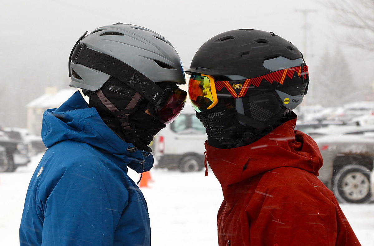 An image of Erica and Dylan getting psyched up helmet-to-helmet as they get ready for some turns in the morning's fresh snow
