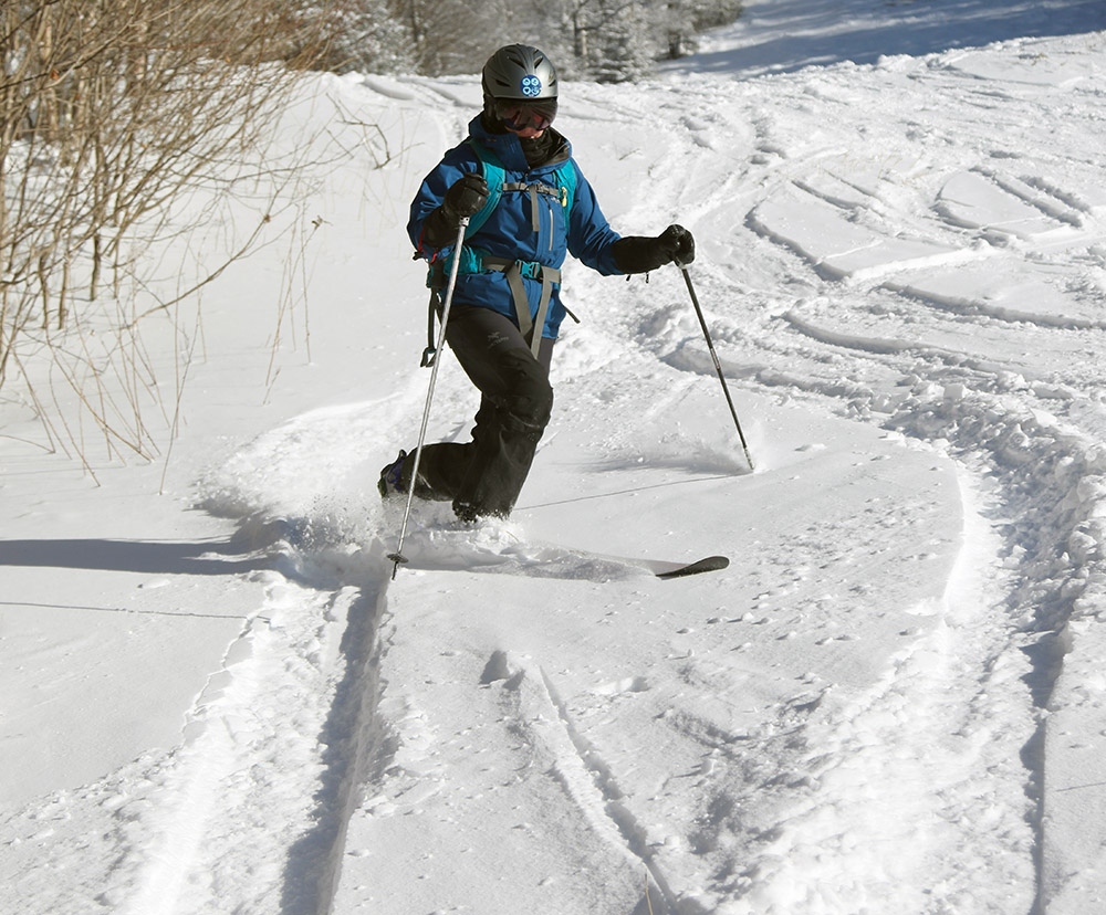An image of Erica skiing in some powder on the Wilderness Lift Line trail during a ski tour at Bolton Valley Resort in Vermont 