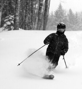 An image of Dylan skiing powder during Winter Storm Izzy at Bolton Valley Resort in Vermont