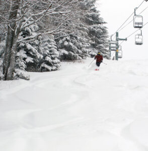 An image of Dylan skiing powder on the Wilderness Lift Line at Bolton Valley Resort in Vermont during Winter Storm Izzy