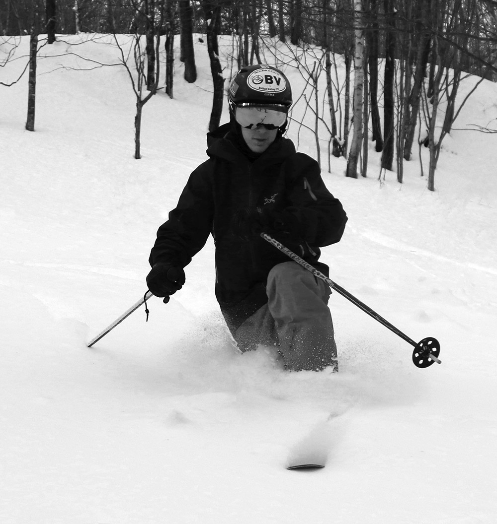 An image of Ty getting in some Telemark ski turns in powder near the Bolton Lodge on the Nordic & Backcountry Network at Bolton Valley Resort in Vermont