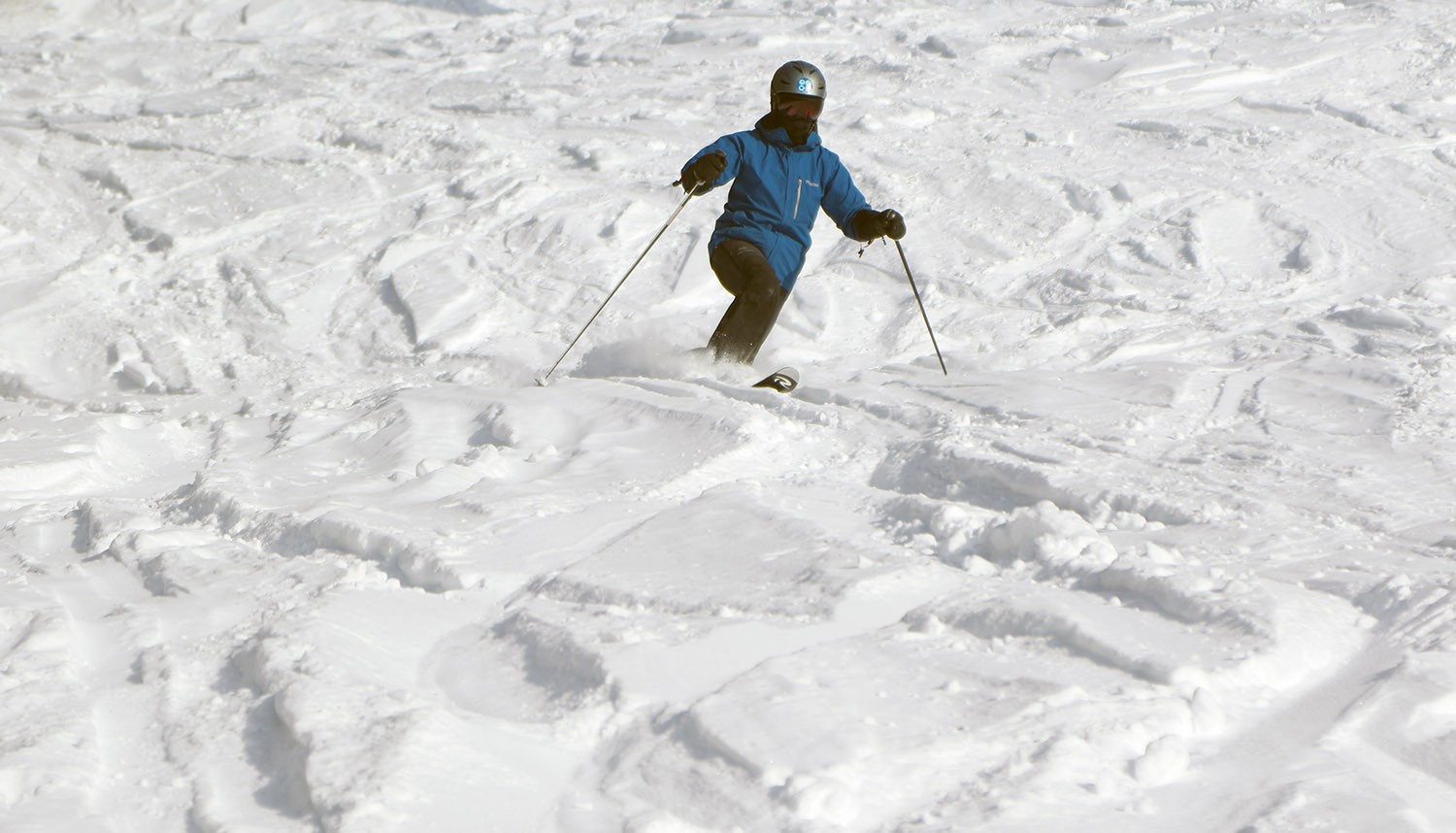 Erica Telemark skiing in some chopped up powder on the Showtime trail at Bolton Valley Ski Resort in Vermont