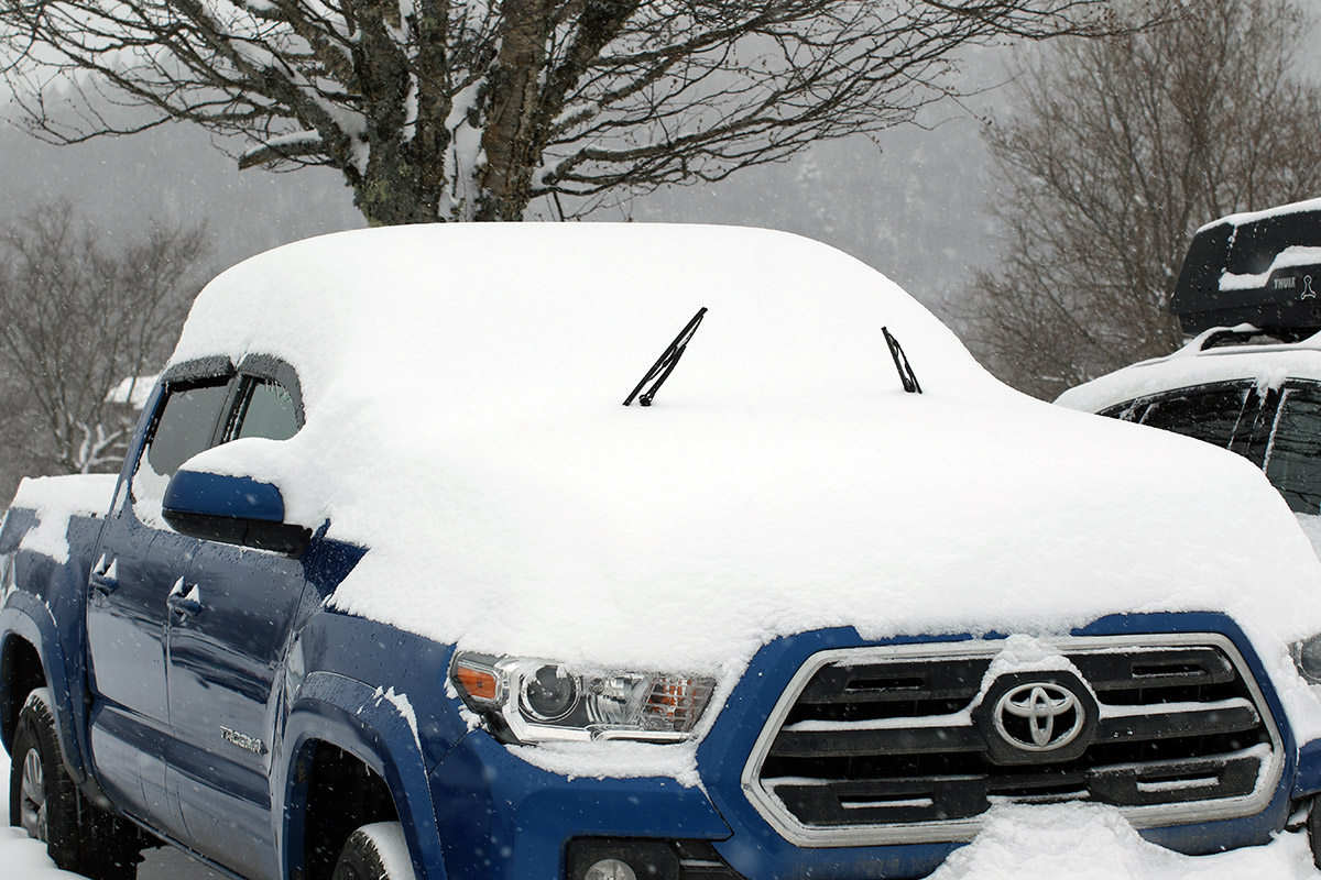 An image of a snow-laden pickup truck during Winter Storm Landon in one of the parking lots at Bolton Valley Ski Resort in Vermont