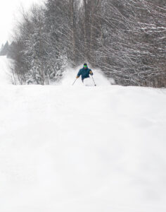 An image of Dave spraying powder while skiing during Winter Storm Landon at Bolton Valley Resort in Vermont