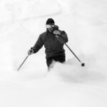 A black and white image of Dave in the powder of Winter Storm Landon at Bolton Valley Resort in Vermont