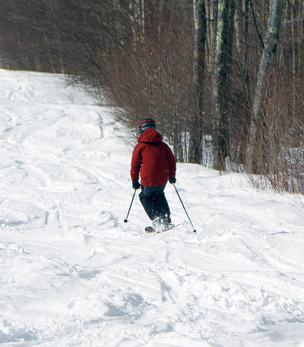 An image of Dylan skiing the Showtime trail of the Timberline area at Bolton Valley Ski Resort in Vermont