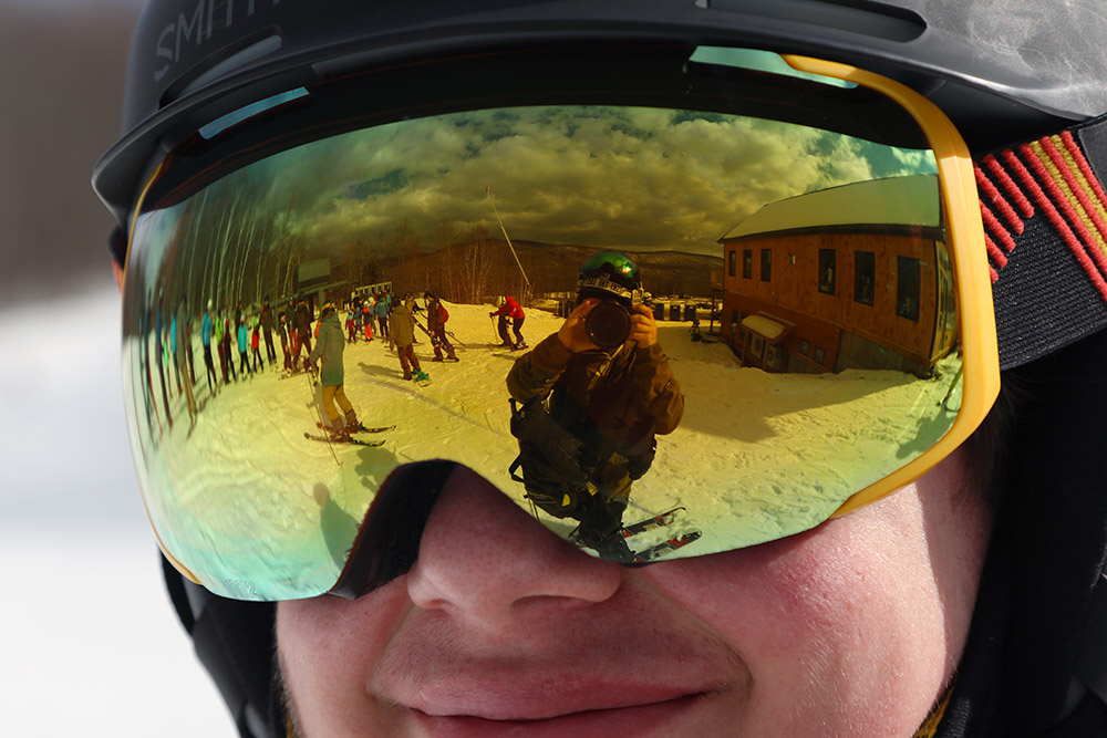 An image of Dylan in ski goggles smiling on a February day at the Timberline area of Bolton Valley Ski Resort in Vermont