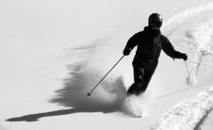 An image of Erica Telemark skiing in powder from Winter Storm Oaklee at Bolton Valley Ski Resort in Vermont