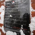 An image of the Miso Kome restaurant Menu with snow from Winter Storm Quinlan in the base area of Bolton Valley Ski Resort in Vermont