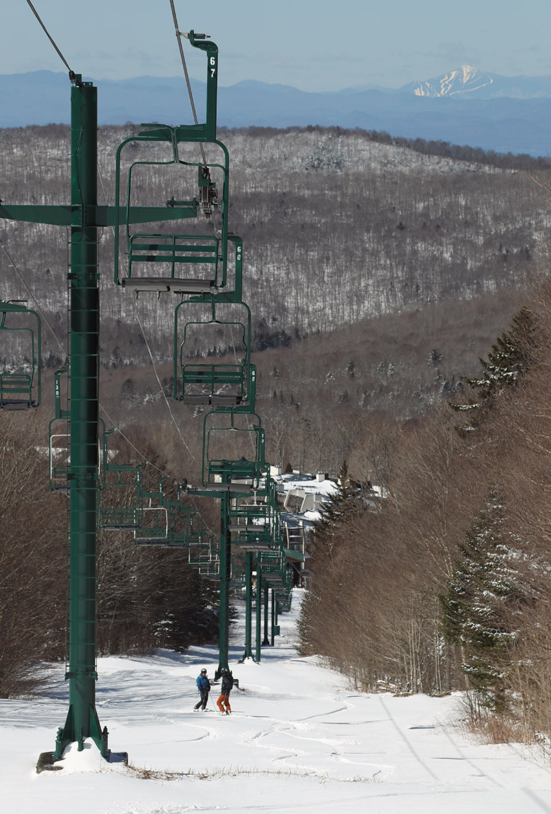 An image of Erica and Ty on the Wilderness Lift line after a spring snowstorm at Bolton Valley Ski Resort in Vermont