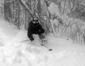 An image of Ty Telemark skiing in deep powder from Winter Storm Diaz on the Bolton Outlaw Trail at Bolton Valley Ski Resort in Vermont