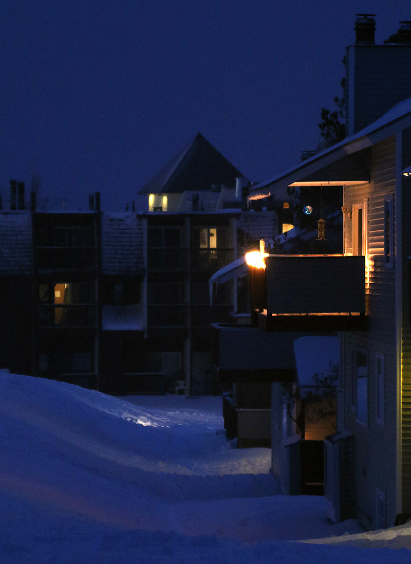 An image of some of the condominiums and the hotel at the bottom of the Wilderness Double Chairlift around dusk in the Village area at Bolton Valley Ski Resort in Vermont
