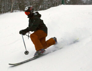 An image of Ty Telemark skiing in some packed natural snow on the Wilderness Lift Line at Bolton Valley Resort in Vermont