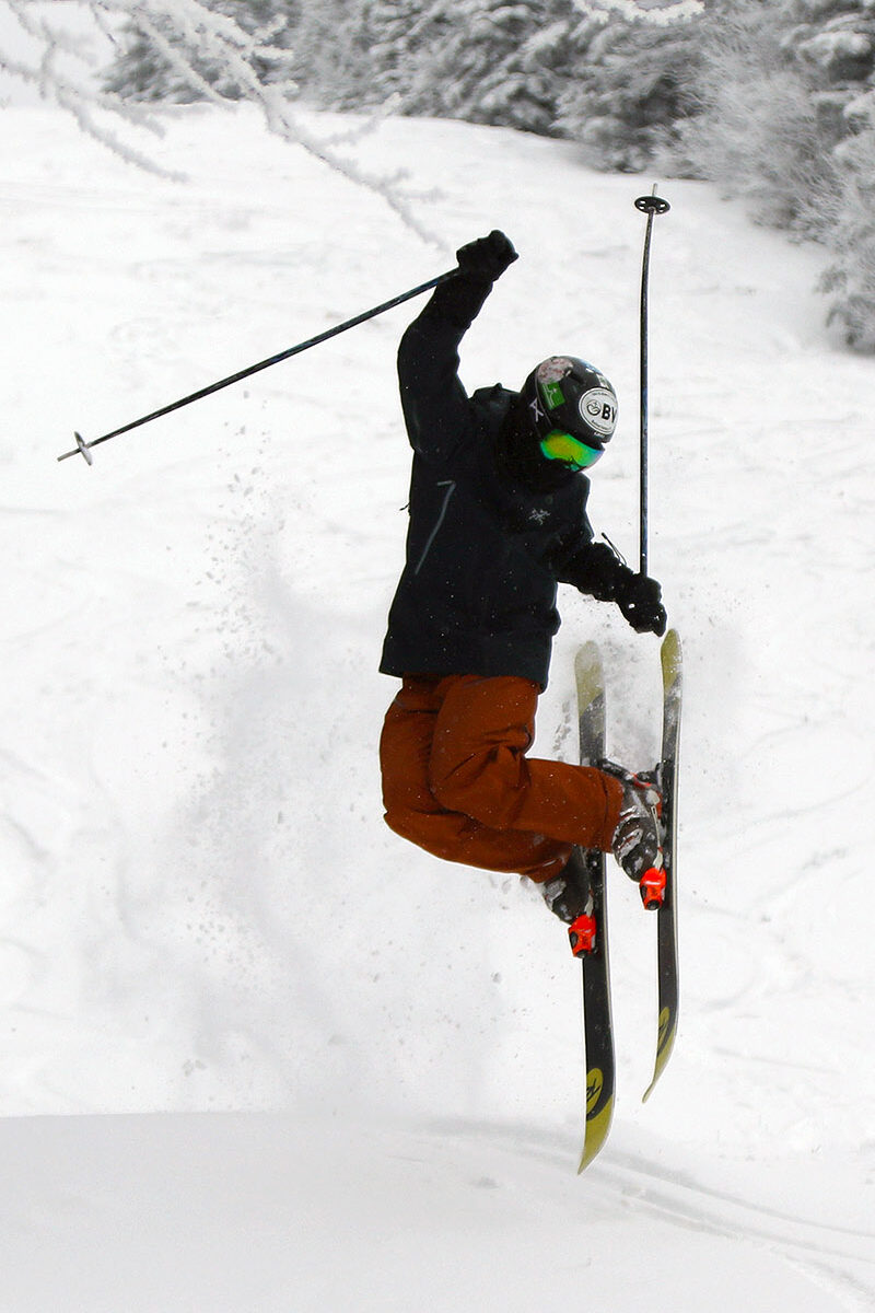 An image of Ty performing a drop tip aerial in recent snows from Winter Storm Iggy at Bolton Valley Ski Resort in Vermont