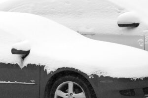 An image of cars with fresh snow on them in the Village area of Bolton Valley Ski Resort in Vermont