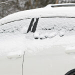 An image of a car with a light accumulation of snow in the Village area of Bolton Valley Ski Resort in Vermont
