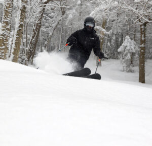 An image of Parker skiing in bottomless powder snow at Bolton Valley Resort in Vermont