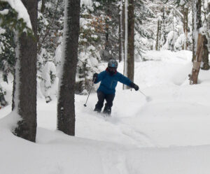 An image of Erica powder skiing in the Wood's Hole area of Timberline after Winter Storm Kassandra at Bolton Valley Ski Resort in Vermont