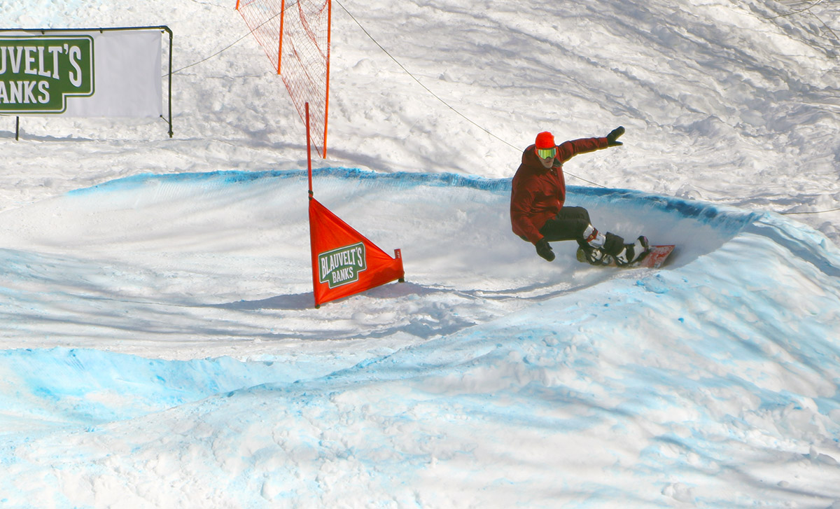 An image showing a snowboarder on a curve of the Blauvelt's Banks race course at Bolton Valley Ski Resort in Vermont
