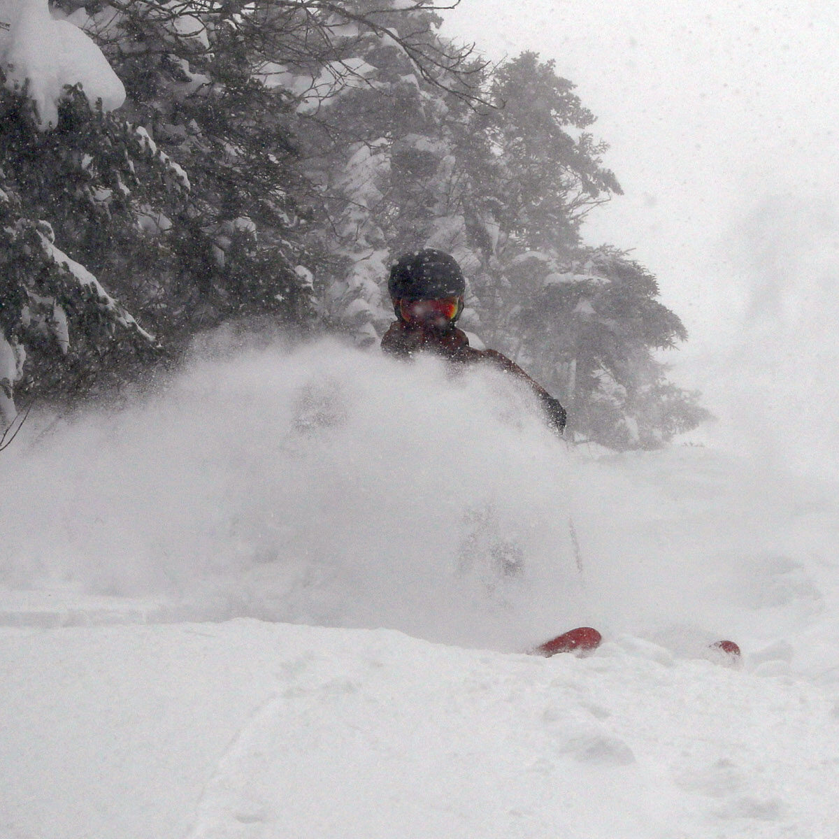 An image of Dylan skiing deep powder on the steep headwall of the Wilderness Liftline during Winter Storm Sage at Bolton Valley Resort in Vermont