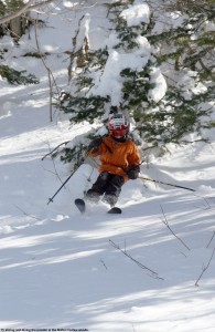 A picture of Ty skiing powder in the trees around Bolton Outlaw