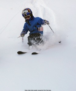 An image of Dylan skiing in powder