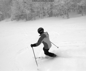 An image of Erica skiing powder