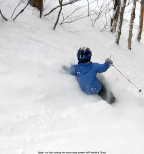 Image of Dylan skiing powder at Stowe