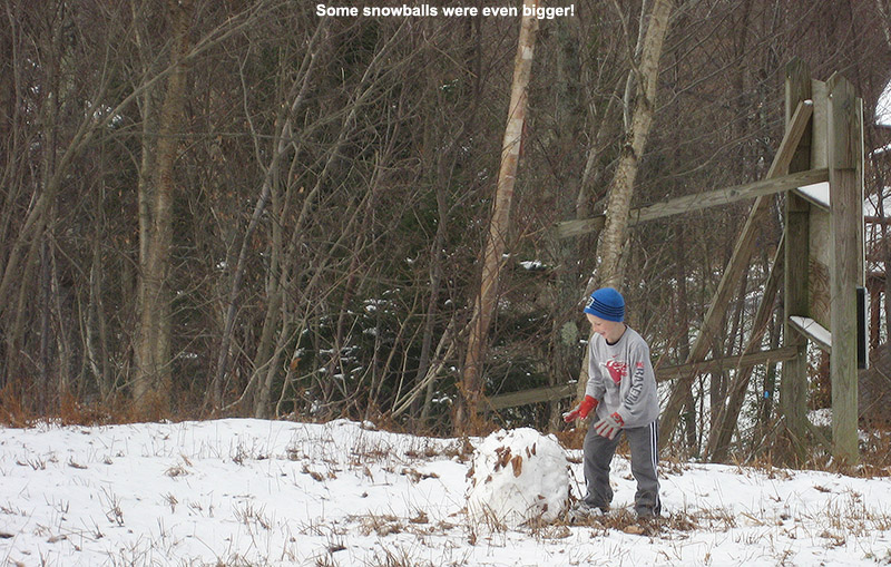An image of Ty rolling a snowball at Bolton Valley Resort in Vermont after a November snowfall
