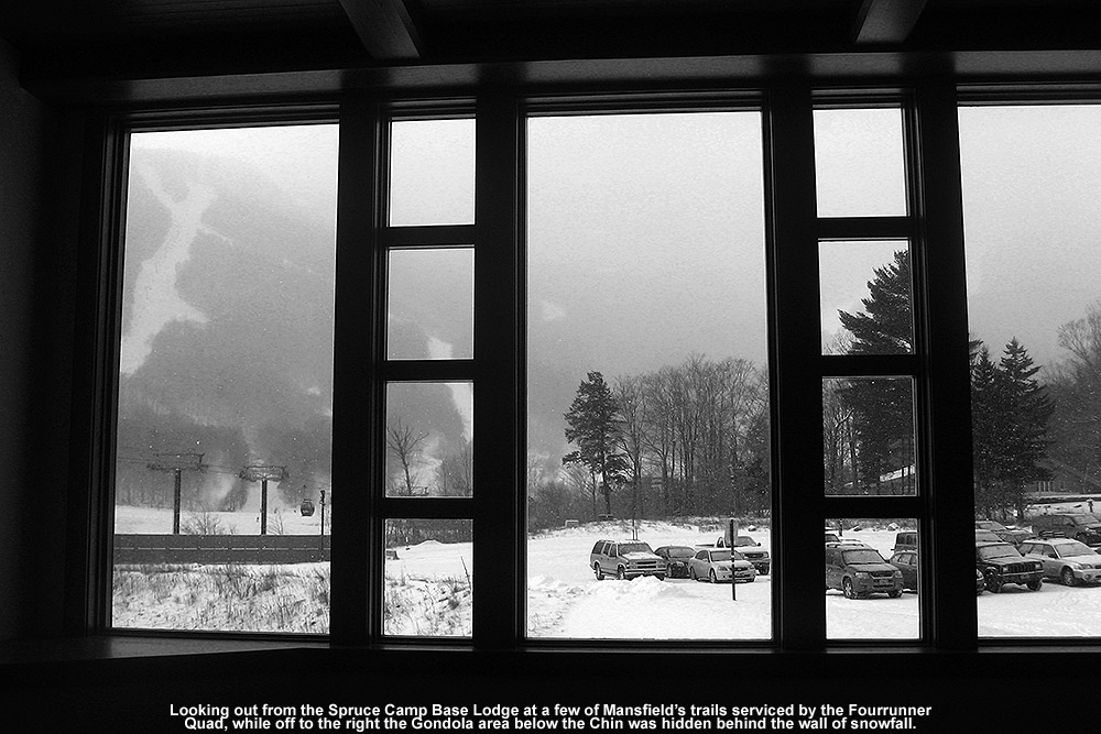 An image of Mt. Mansfield shrouded in snowfall taken from the Spruce Camp Base Lodge at Stowe Mountain Resort in Vermont