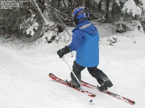 An image of Dylan Telemark skiing along the side of Bear Run at Bolton Valley Resort in Vermont
