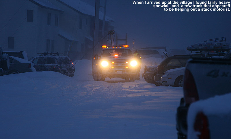 An image of a tow truck helping a stuck car int he Bolton Valley village during heavy snowfall from a storm on Decmeber 28, 2011
