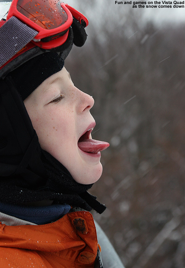 An image of Ty catching snowflakes on his tongue while we ride the Vista Quad Chairlift at Bolton Valley Ski Resort in Vermont