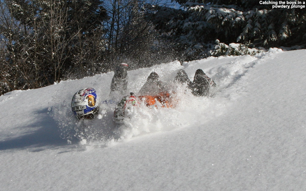 An image of Ty and Dylan sliding in powder off one of the snow whales on the Villager Trail at Bolton Valley Ski Resort in Vermont