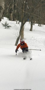 An image of Ty skiing powder in the Outlaw Glades at Bolton Valley Ski Resort in Vermont
