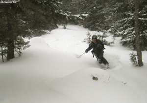 An image of Jay skiing powder in one of the glades off the Catamount Trail past Bolton Valley Ski Resort's Nordic & Backcountry terrain