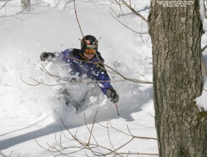 An image of Jay skiing deep powder in the Ridge Run trees on Spruce Peak at Stowe Mountain Resort in Vermont
