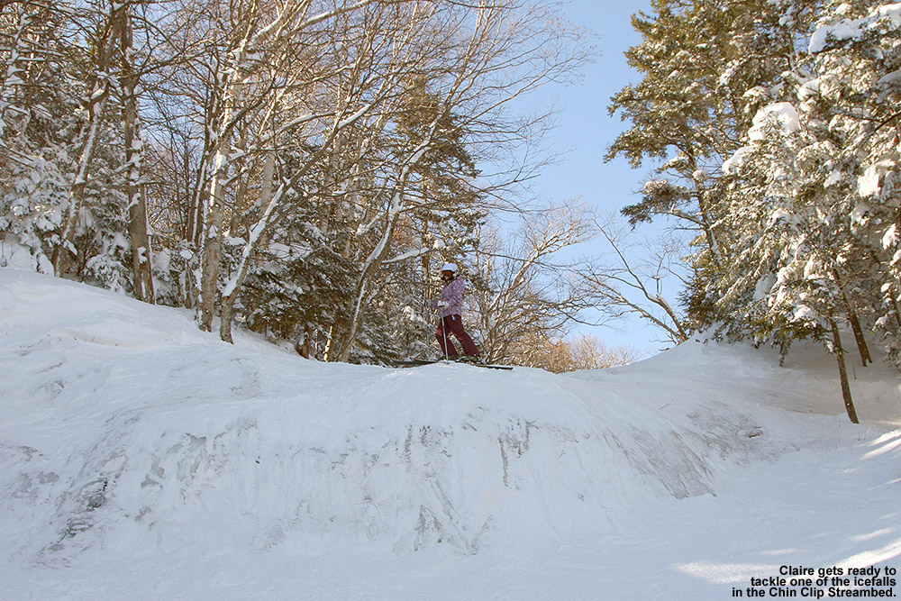 An image of Claire atop one of the waterfalls in the Chin Clip Streambed at Stowe Mountain Ski Resort in Vermont