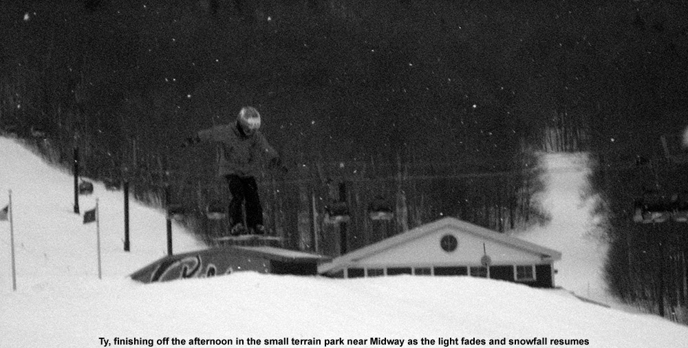 An image of Ty jumping over a sloped box in the small terrain park near the Midway Lodge at Stowe Mountain Ski Resort in Vermont